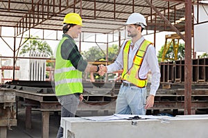 Engineers shaking hands at construction site, Construction workers handshake with factory foreman worker at the precast factory