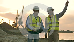 Engineers are talking at the shore of a quarry