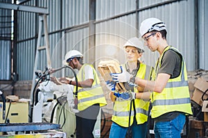 Engineers team mechanic using computer controller Robotic arm for welding steel in steel factory workshop. Industry robot