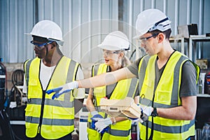 Engineers team mechanic using computer controller Robotic arm for welding steel in steel factory workshop. Industry robot