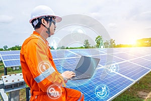 Engineers upload data of power energy to a laptop for checking the performance of the solar panel to confirming systems working