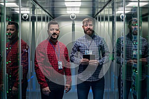 IT engineers using VR glasses in server room