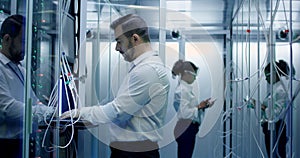 Engineers work with cables in the server room