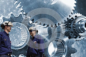 Engineers, workers with cog and gear machinery
