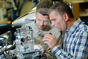 Engineers working on engine in hangar