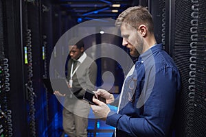 Engineers Working in Modern Data Center Server Room