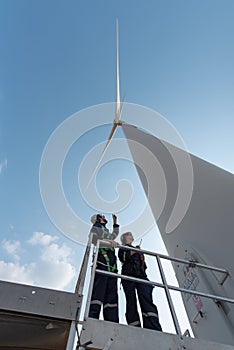 Engineers working on site in wind turbine farm, Wind turbines generate clean energy source, Eco technology for electric