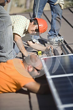 Engineers Working On Solar Panel At Rooftop