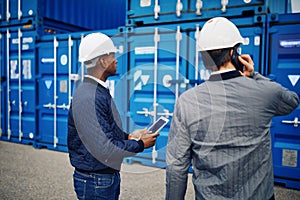 Engineers working together in a large commercial shipyard