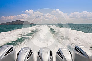 Engines of speed boat are driving along waving of water on ocean