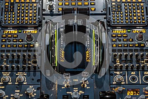 Engines thrust levers inside a big jet plane