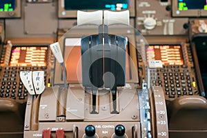 Engines thrust levers inside a big jet plane photo