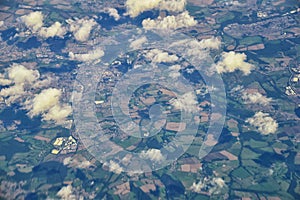 England rural landscape, fields, meadows and clouds. Aerial view from airplane of endless lush pastures and farmlands. Beautiful E