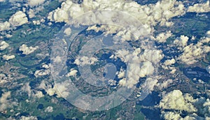 England rural landscape, fields, meadows and clouds. Aerial view from airplane of endless lush pastures and farmlands. Beautiful E