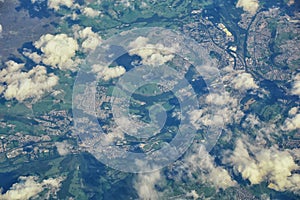 England rural landscape, fields, meadows and clouds. Aerial view from airplane of endless lush pastures and farmlands. Beautiful E