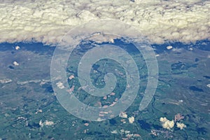 England rural landscape, fields, meadows and clouds. Aerial view from airplane of endless lush pastures and farmlands. Beautiful E