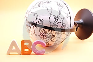 English ABC alphabet letters next black and white globe