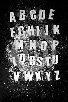English alphabet. letters made of concrete on a black background.