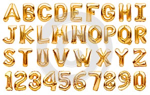 English alphabet and numbers made of golden inflatable helium balloons isolated on white. Gold foil balloon font, full alphabet photo