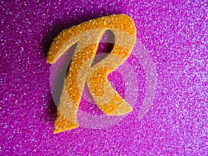 An English alphabet R pink background shiney photo