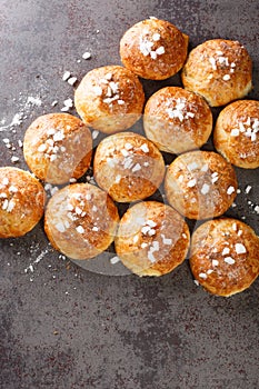English bath buns roll with cumin and sugar close-up. Vertical top view