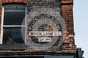 English and Bengali street name signs on a building in Brick Lane, London, UK