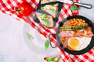 English breakfast concept with avocado toast over blue vintage background.