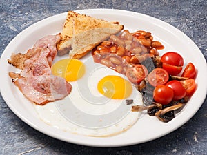 English Breakfast: eggs, beans, bacon, mushrooms, toast