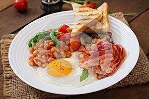 English breakfast - fried egg, beans, tomatoes, mushrooms, bacon