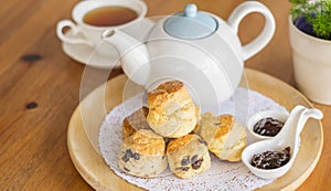 English breakfast and tea break. scones on wooden table with a cup of tea.