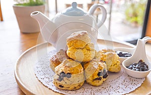 English breakfast and tea break. scones on wooden table with a cup of tea.