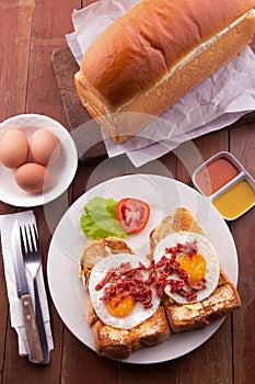 English Breakfast: toast, sunny side up eggs, bacon, ham and salad