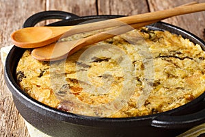 English Bubble and Squeak of baked mashed potatoes with cabbage and brussels sprouts close-up in a pan