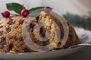English christmas pudding with spoon. Traditional English steamed pudding with dried fruits and nuts for Christmas on the backgrou