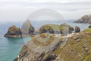 English coast wirg sandy beach, rocks on hazy day