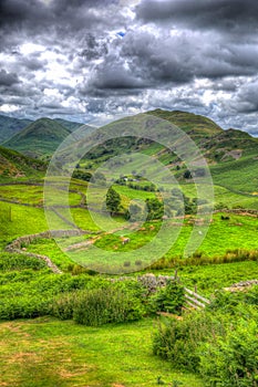English countryside scene the Lake District with valley and mountains and green fields in HDR