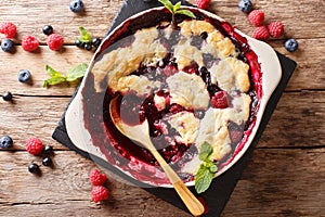 English cuisine: berry cobbler is decorated with mint closeup. photo