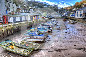 English harbour Polperro Cornwall South West England UK out of season in winter with boats at low tide HDR