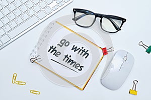 English idiom hand lettering about time - go with the times on wooden blocks