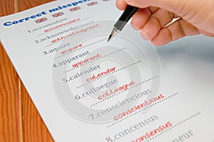 English misspelling worksheet with pen and tablet photo