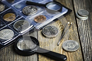 English old coin, magnifier and tweezers, numismatics