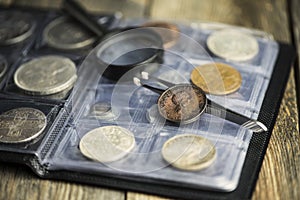 English old coin, magnifier and tweezers, numismatics