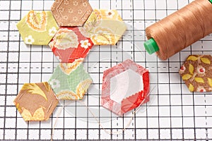 English paper pieced hexagons on white craft mat