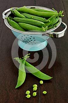 English peas on dark wood background