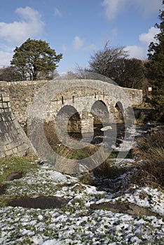 English river with old stone bridge on Dartmoor England UK