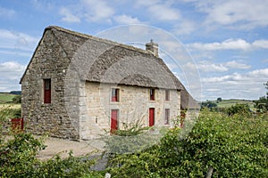 English stone cottage with a thatch roof