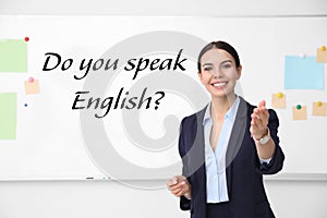 English teacher near whiteboard in classroom