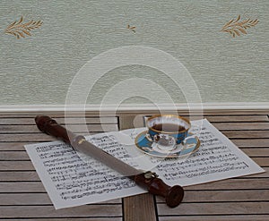 English teacup with saucer, fine bone china porcelain, and a block flute on a sheet of music