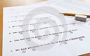 English test and answer sheet on table