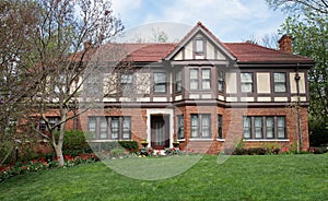 English Tudor Home with Red Spring Tulips